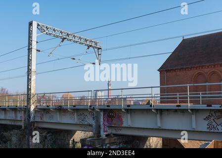 Power cables suspended over railway for electric train Stock Photo