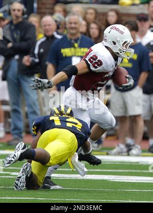 Massachusetts tailback Jonathan Hernandez, 22, cuts to avoid Rhode