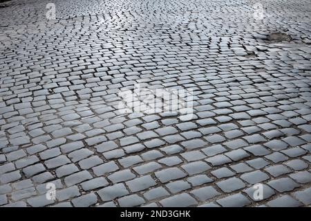 Old stone cobblestones from which the road is paved Stock Photo
