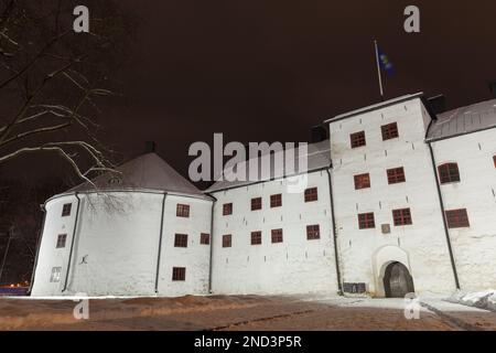 Illuminated Turku Castle exterior at night, it is a medieval building in the city of Turku in Finland. It was founded in the late 13th century and sta Stock Photo