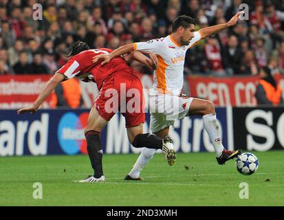 Munich s Daniel van Buyten left and AS Roma s Marco Borriello