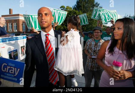 Washington Mayor Adrian Fenty carries daughter Aerin as wife