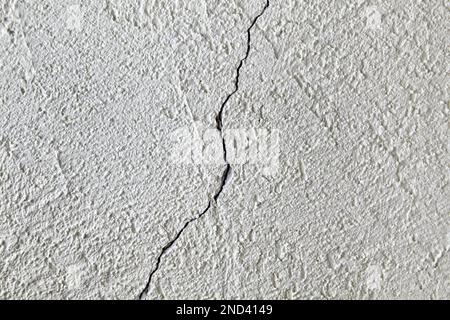 A crack in a white concrete plastered wall. Stock Photo