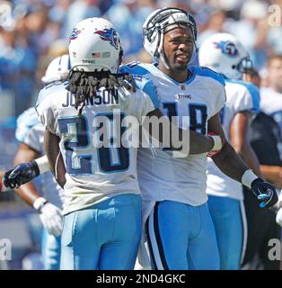 Tennessee Titans running back Chris Johnson, right, hugs Seattle Seahawks' T.J.  Houshmandzadeh after the Titans won 17-13 Sunday, Jan. 3, 2010, in an NFL  football game in Seattle. On Sunday, Johnson became