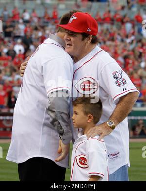 Former Cincinnati Reds great Pete Rose (14) hugs Tommy Helms