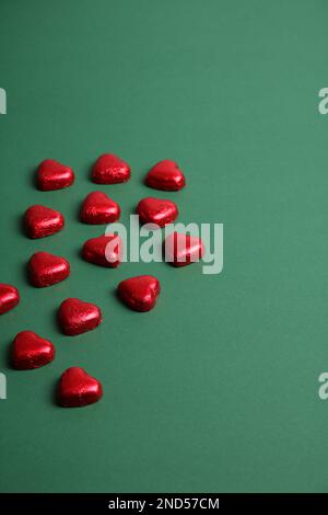 A photo of a lot of red candy in the shape of hearts on a homogeneous background Stock Photo
