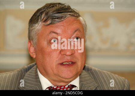 FIDE presidential candidate and former World Chess Champion, Anatoly Karpov,  lower, reacts as former World Chess Champion, Garry Kasparov walks pass  before the start of their World Chess Federation (FIDE) presidential  election