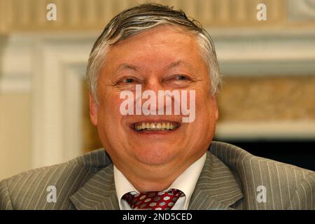 FIDE presidential candidate and former World Chess Champion, Anatoly  Karpov, lower, reacts as former World Chess Champion, Garry Kasparov walks  pass before the start of their World Chess Federation (FIDE) presidential  election