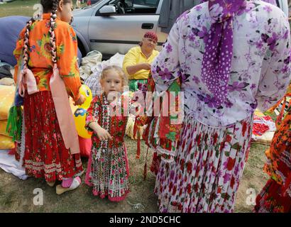 A Romanian Gypsy girl looks on in Costesti, Romania, 250 west of
