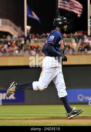 Minnesota Twins third baseman Nick Punto #8 slides into third base on a  single by Denard Span #2 in the 2nd inning of the Twins' baseball game  against the Chicago White Sox