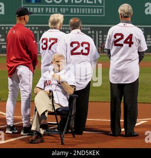 Boston Red Sox legend Johnny Pesky gestures to cheering fans as