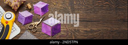 Diamonds stitched in the form of a cube. The process of sewing a quilt. Stock Photo