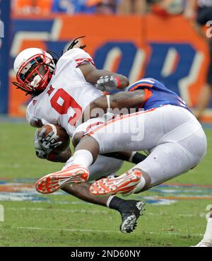 Miami (Ohio) receiver Jamal Rogers (9), defended by Michigan linebacker Jonas  Mouton (8) loses control of the ball during the first quarter of an NCAA  college football game in Ann Arbor, Mich.