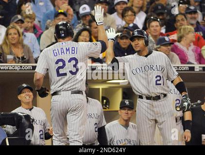 Colorado Rockies' Jason Giambi, left, is congratulated by teammate Troy  Tulowitzki after hitting a three-run home run off Kansas City Royals  starting pitcher Zack Greinke during third inning of a baseball game