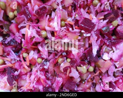 Vinaigrette - a salad of finely chopped vegetables of beets, potatoes, sauerkraut, pickles, carrots and peas Stock Photo