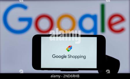 In this photo illustration, the logo of Google Shopping is seen displayed on a mobile phone screen with a Google logo in the background. Stock Photo