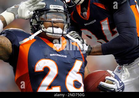 Denver Broncos head coach Josh McDaniels (R) congratulates running back  LenDale White (26) after his two-yard touchdown run against the Pittsburgh  Steelers during the first quarter at Invesco Field at Mile High