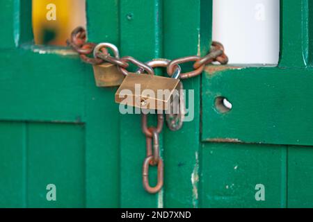 Close-up on a chain and a padlock closing a door. Stock Photo
