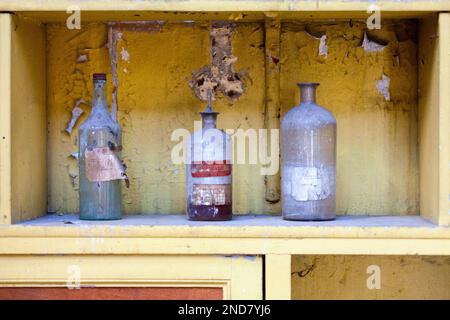 Close-up on hundred years old bottles of chemicals on a shelf. Stock Photo