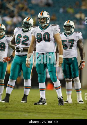 Miami Dolphins defensive tackle Josiah Bronson (95) reacts after taking  down Jacksonville Jaguars running back Travis Etienne Jr. (1) during the  first quarter of an NLF preseason football gam Saturday, Aug. 26