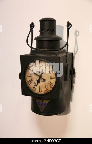 Cracow. Krakow. Poland. Old vintage handheld railway station clock with clockface illuminated by built-in kerosene lamp. Stock Photo