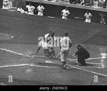 FILE - In this Sept. 28, 1955, file photo, Brooklyn Dodgers' Jackie Robinson  safely steals home plate under the tag of New York Yankees catcher Yogi  Berra in the eighth inning of