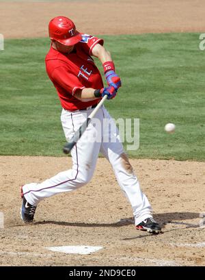 The Texas Rangers' Michael Young connects in the batting cage as teammate  Ian Kinsler looks on during spring training in Surprise, Arizona, Saturday  February 25, 2012. (Photo by Ron T. Ennis/Fort Worth