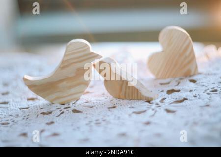 pair of wooden carved handmade toy birds. Eco-friendly wooden educational toys based on the Montessori method. Wooden toys, handmade toys for Stock Photo