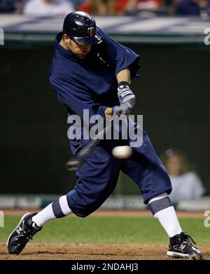 Minnesota Twins' J.J. Hardy hits a fly ball to left field in the sixth  inning of a baseball game against the Detroit Tigers Tuesday, April 27, 2010  in Detroit. Tigers' left fielder