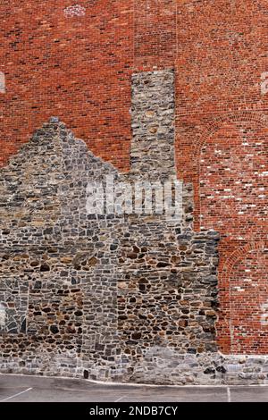 Canada,Quebec,Montreal,outline of old house in fieldstone as part of a red brick building in downtown Montreal Stock Photo
