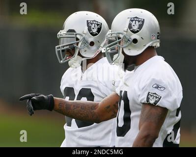 Oakland Raiders running backs Darren McFadden, left, and Rock Cartwright,  right, rest between drills during their NFL football training camp in Napa,  Calif., Thursday, July 28, 2011. (AP Photo/Eric Risberg Stock Photo 