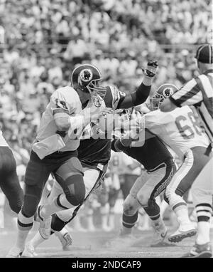 The ball pops free as Washington Redskins quarterback Jay Schroeder is hit  by Giants Leonard Marshall while trying to pass during the third quarter of NFC  Championship game in East Rutherford, N.J.