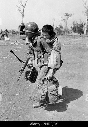 A soldier of the South Vietnamese army carries a bandolier of heavy ...