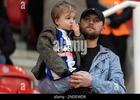 Dad and lad Huddersfield Town fan’s watch on during the Sky Bet Championship match Stoke City vs Huddersfield Town at Bet365 Stadium, Stoke-on-Trent, United Kingdom, 15th February 2023  (Photo by Phil Bryan/News Images) Stock Photo