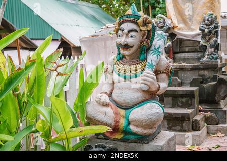 Traditional Balinese guard statue usually placed at entry points to private or public places. Two blurred guard statues at background Stock Photo