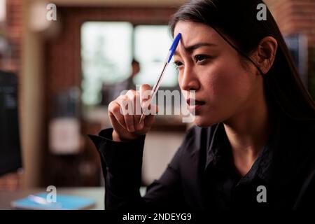 Tired tech programmer brainstorming ideas about coding solution, finding algorithm to create database script. Developer feeling pensive and thinking about software developing system in it agency Stock Photo