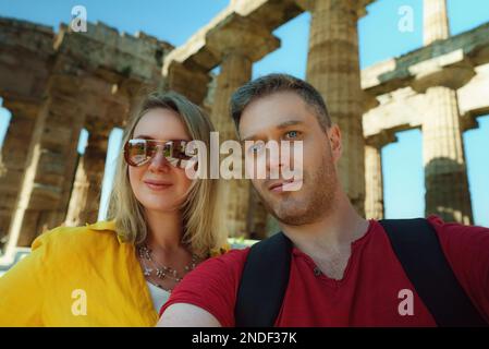 Couple take selfie in front of the remains of the ancient temple. Stock Photo