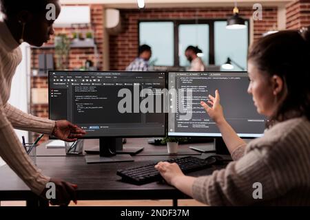 Multi ethnic tech enginners developing html code and cloud computing in it development agency. Cloud developer working on database programming with html script, computing big data. Stock Photo