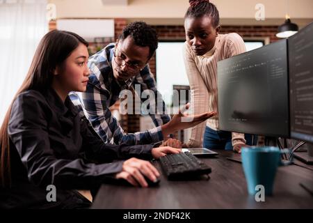 Diverse ai cloud programers talking about html script, looking at code on computer, working on server interface development. Programmers parsing cloud computing project with big data in it agency Stock Photo