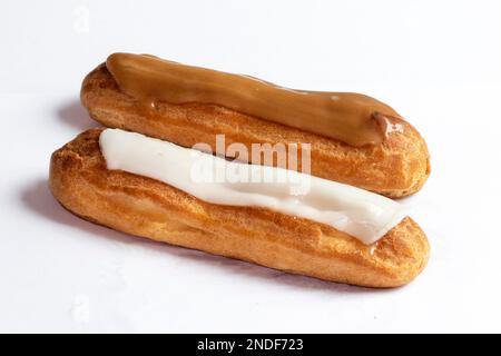 Coffee eclair and vanilla eclair pastry on white background Stock Photo