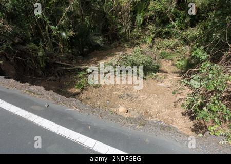 Following tropical storm Cyclone Gabrielle a land slip has occurred forming a large crater where land once was.Roadside edge can be seen to have been Stock Photo