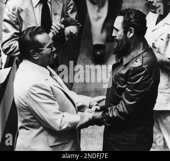 Cuban President Fidel Castro shakes hands with an unidentified ...