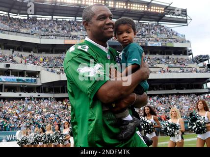 Philadelphia Eagles former quarterback Randall Cunningham holds his young  son, Christian as he is inducted into the Eagles Honor Roll during half  time ceremonies in Philadelphia at Lincoln Financial Field September 27