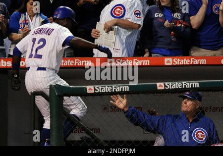 Chicago Cubs manager Lou Piniella (C) waits on the mound for a new