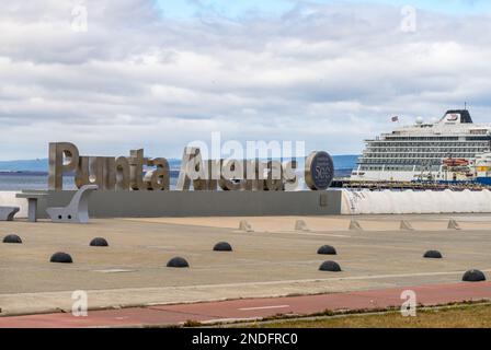 Punta Arenas, Chile - 27 January 2023: Commemorative sign for 500 years since Magellan with cruise ship Stock Photo