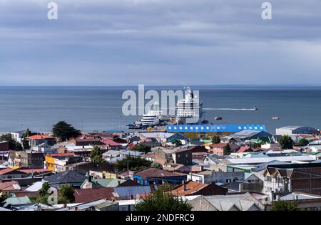 Punta Arenas, Chile - 27 January 2023: Panorama of city of Punta Arenas with cruise ship in harbor Stock Photo