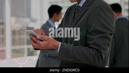 Composition of financial data processing over caucasian businessman using smartphone Stock Photo
