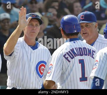 Chicago Cubs bench coach Alan Trammell, right, reacts as Derrek