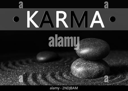 Karma concept. Black sand and stones against dark background Stock Photo