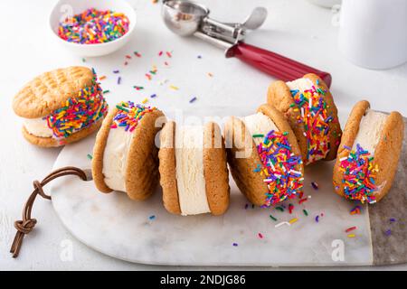 Ice cream sandwiches with vanilla ice cream and peanut butter cookies and sprinkles Stock Photo